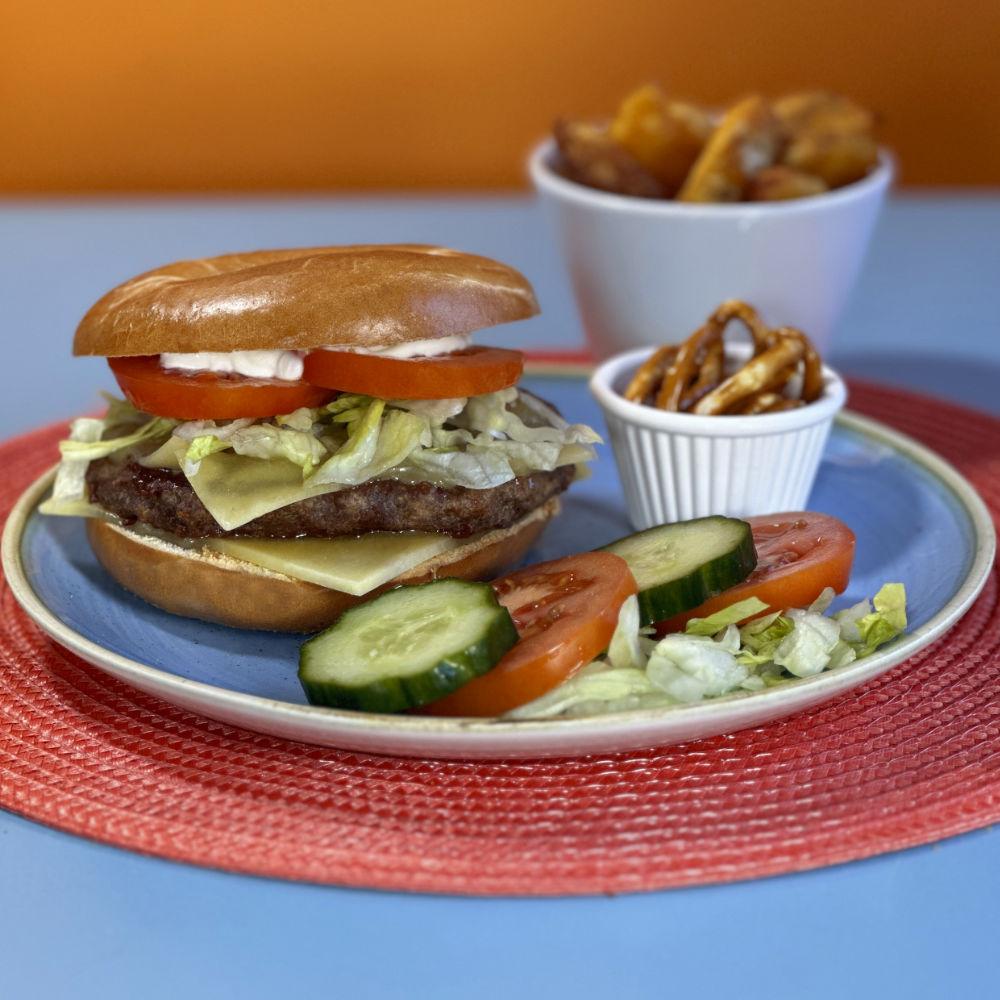 Classic Burger Bagel a classic combo of Devon beef burger with cheese and salad, a timeless delight!
