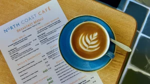 Flat white coffee at North Coast Cafe in Lynton, served with silky microfoam and crema.